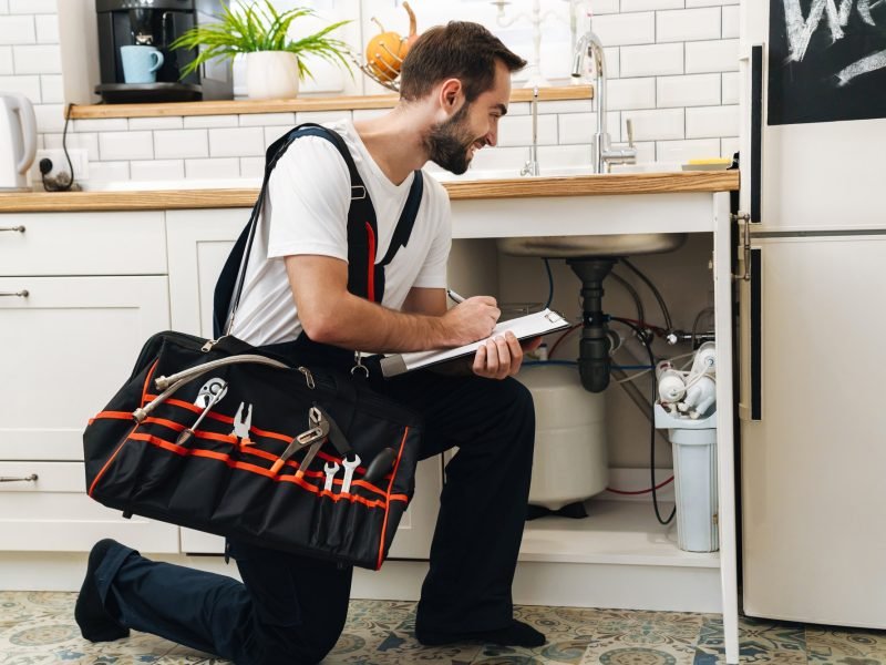 image-of-plumber-man-with-equipment-and-clipboard-working-in-apartment.jpg